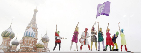 Masked protestors waiving a flag outside in snowy Russia